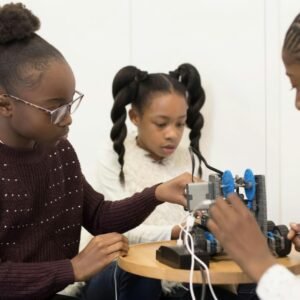 two girls are working on a project together
