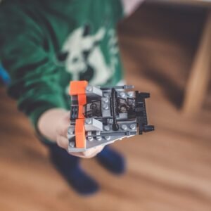 person holding black and white lego blocks